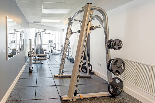 480 NE 30th St Unit 1807, Miami, FL 33137 - exercise room featuring baseboards and a paneled ceiling