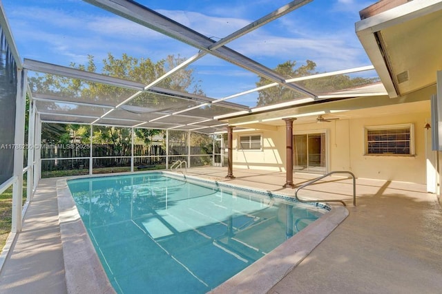 view of swimming pool featuring fence, ceiling fan, a fenced in pool, a patio area, and a lanai