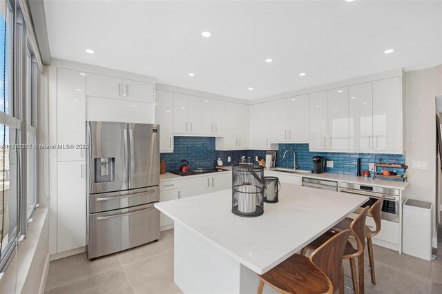 2899 Collins Ave Pha, Pha, Miami Beach, FL 33140 - kitchen with light tile patterned flooring, appliances with stainless steel finishes, a sink, and modern cabinets