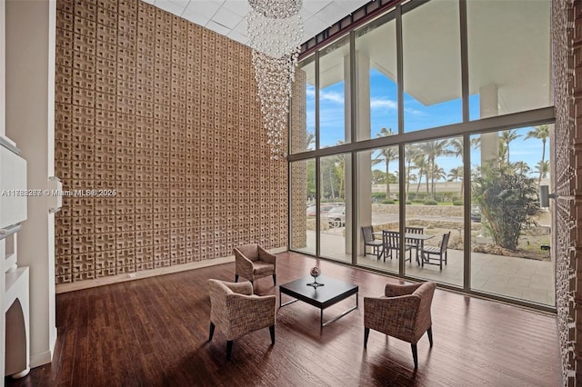 2899 Collins Ave Pha, Pha, Miami Beach, FL 33140 - living area with a high ceiling, an inviting chandelier, wood finished floors, and a wall of windows