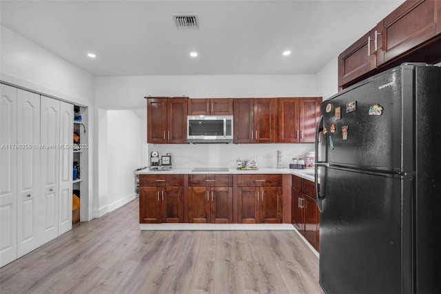 1814 NW 73rd St, Miami, FL 33147 - kitchen featuring black appliances, light wood finished floors, light countertops, recessed lighting, and baseboards
