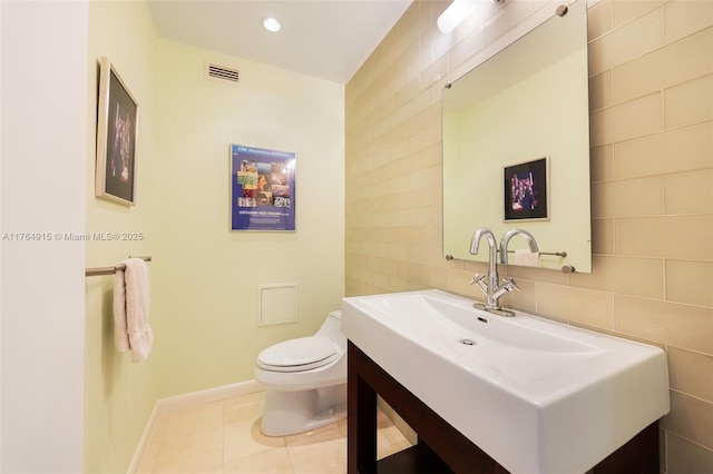 4925 Collins Ave Unit 8G, Miami Beach, FL 33140 - bathroom featuring visible vents, toilet, vanity, tile walls, and baseboards