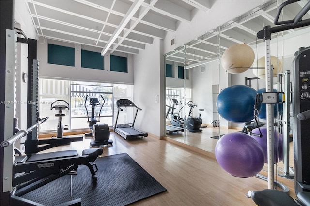 4925 Collins Ave Unit 8G, Miami Beach, FL 33140 - exercise room featuring a towering ceiling, wood finished floors, and visible vents