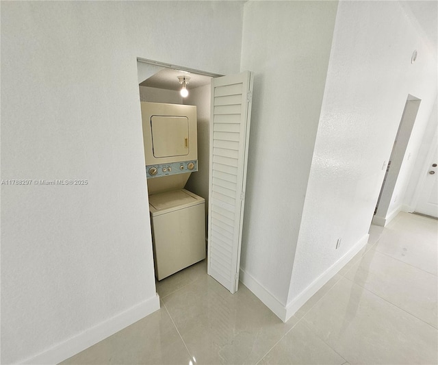 450 NW 84th St Unit 450, Miami, FL 33150 - washroom with stacked washer / drying machine, baseboards, and tile patterned floors