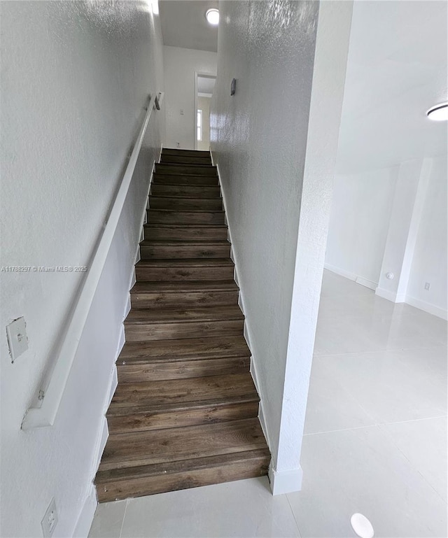 450 NW 84th St Unit 450, Miami, FL 33150 - staircase with a textured wall, baseboards, and tile patterned floors