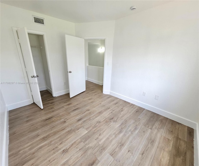 450 NW 84th St Unit 450, Miami, FL 33150 - unfurnished bedroom with light wood-style floors, baseboards, and a closet