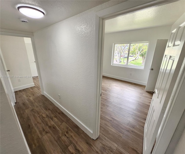 450 NW 84th St Unit 450, Miami, FL 33150 - corridor with a textured wall, wood finished floors, and baseboards
