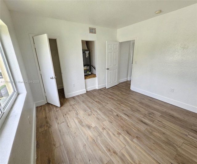 450 NW 84th St Unit 450, Miami, FL 33150 - unfurnished bedroom featuring light wood-style flooring and baseboards
