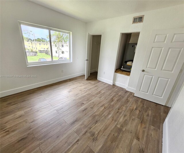 450 NW 84th St Unit 450, Miami, FL 33150 - unfurnished bedroom with wood finished floors and baseboards