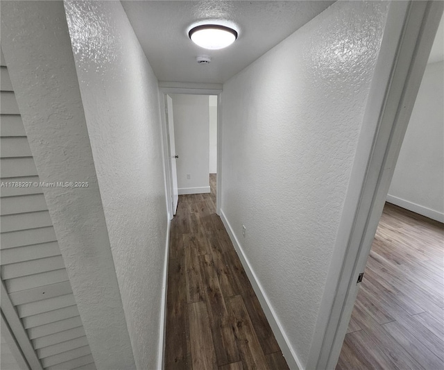 450 NW 84th St Unit 450, Miami, FL 33150 - corridor with a textured wall, wood finished floors, and baseboards