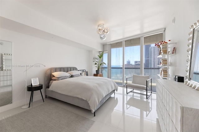 tiled bedroom with a wall of windows and access to exterior