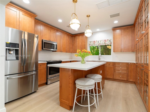5510 San Vicente St, Coral Gables, FL 33146 - kitchen featuring appliances with stainless steel finishes, visible vents, light countertops, and light wood-style flooring