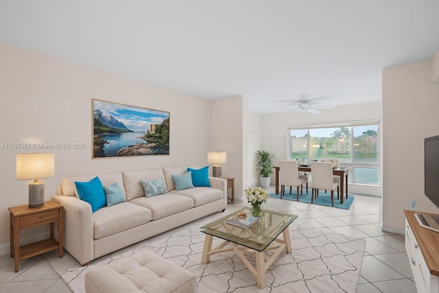 12547 Imperial Isle Dr Unit 204, Boynton Beach, FL 33437 - living room featuring ceiling fan, baseboards, and light tile patterned floors
