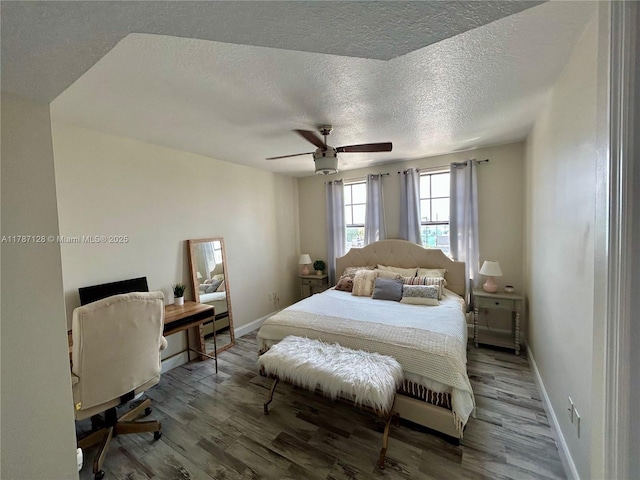 511 Lucerne Ave Unit 408, Lake Worth, FL 33460 - bedroom with a textured ceiling, wood finished floors, ceiling fan, and baseboard heating