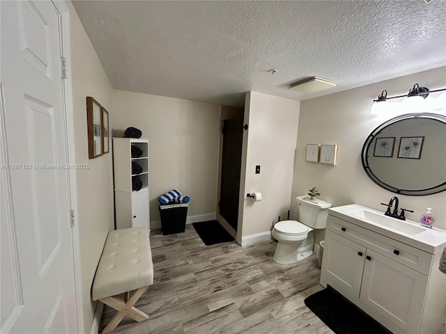 511 Lucerne Ave Unit 408, Lake Worth, FL 33460 - full bath with vanity, wood finished floors, a textured ceiling, toilet, and baseboards