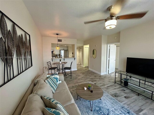 511 Lucerne Ave Unit 408, Lake Worth, FL 33460 - living area featuring light wood-type flooring, ceiling fan, and baseboards