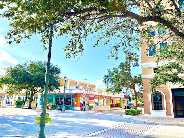 511 Lucerne Ave Unit 408, Lake Worth, FL 33460 - view of asphalt street featuring traffic signs, curbs, sidewalks, and street lighting