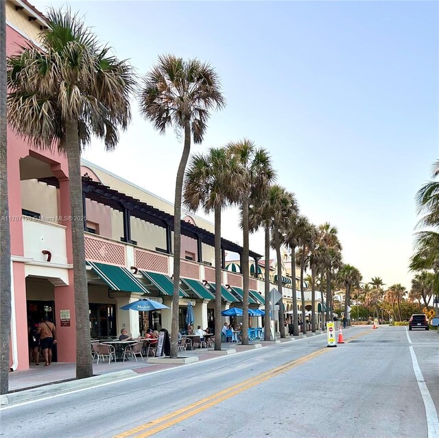 511 Lucerne Ave Unit 408, Lake Worth, FL 33460 - view of asphalt street with sidewalks, curbs, and street lights