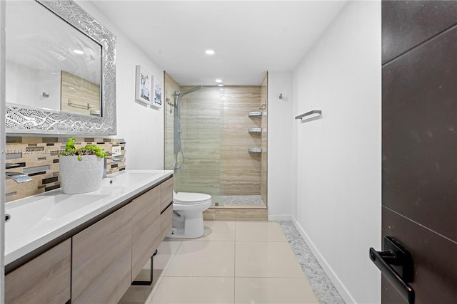 11111 Biscayne Blvd Unit 19G, Miami, FL 33181 - bathroom featuring a shower stall, tile patterned flooring, double vanity, toilet, and decorative backsplash