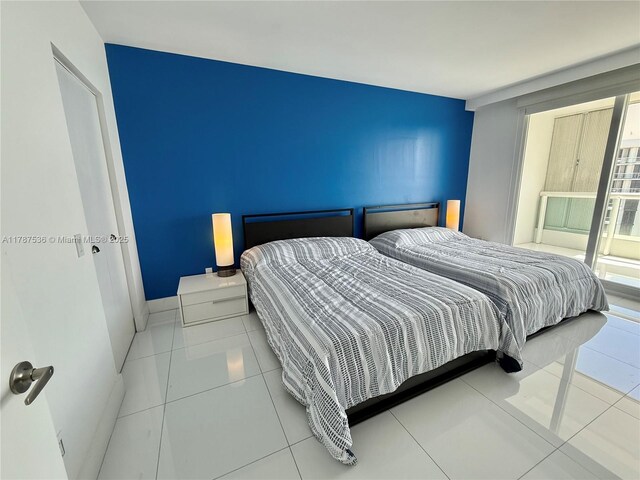 bedroom featuring tile patterned floors and baseboards