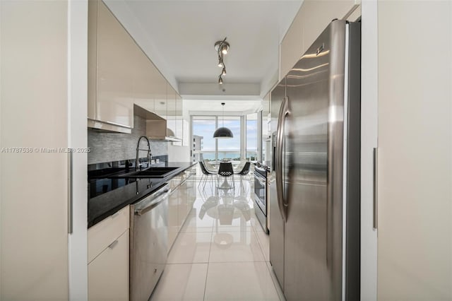21055 Yacht Club Dr Unit 3101, Aventura, FL 33180 - kitchen featuring light tile patterned floors, decorative backsplash, a sink, stainless steel appliances, and modern cabinets