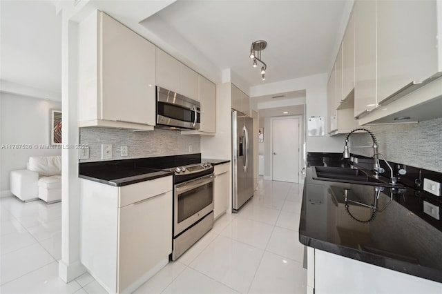 21055 Yacht Club Dr Unit 3101, Aventura, FL 33180 - kitchen featuring tasteful backsplash, stainless steel appliances, light tile patterned floors, dark countertops, and a sink