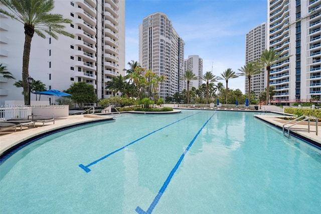 pool with a view of city and a patio