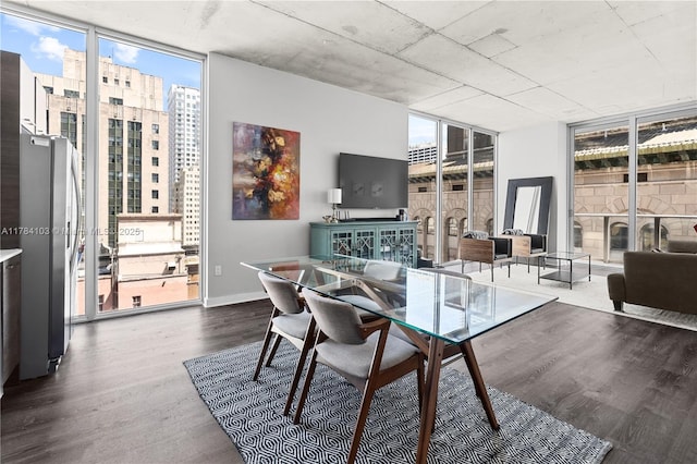 dining room with baseboards, floor to ceiling windows, a wealth of natural light, and dark wood-type flooring