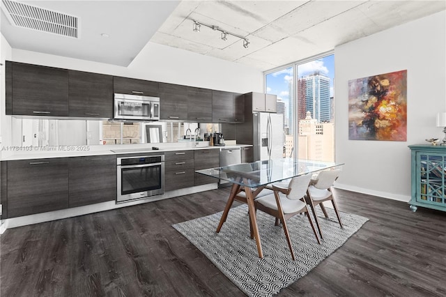 kitchen featuring appliances with stainless steel finishes, visible vents, light countertops, baseboards, and dark wood finished floors