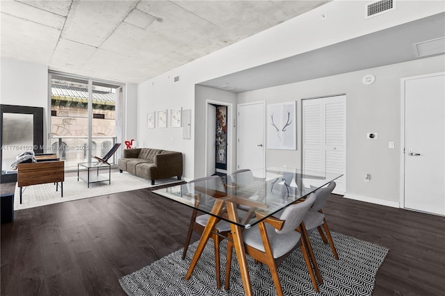 dining space featuring visible vents, wood finished floors, and baseboards