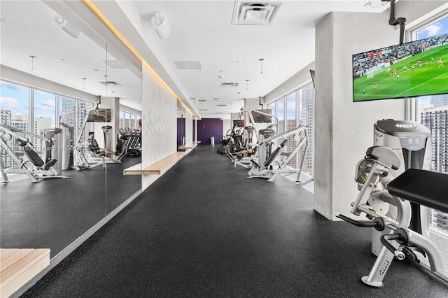 exercise room with a view of city and visible vents