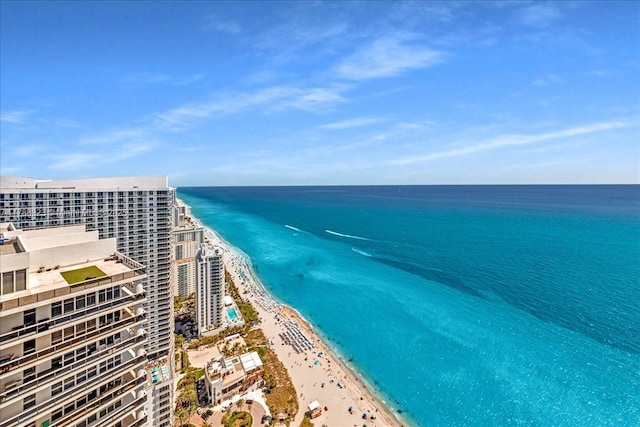 birds eye view of property featuring a beach view and a water view