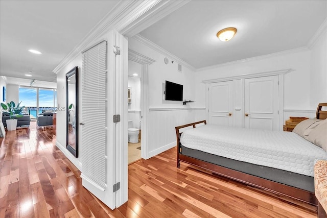1830 S Ocean Dr Unit Lph4910, Hallandale Beach, FL 33009 - bedroom with ornamental molding, wood finished floors, wainscoting, and connected bathroom
