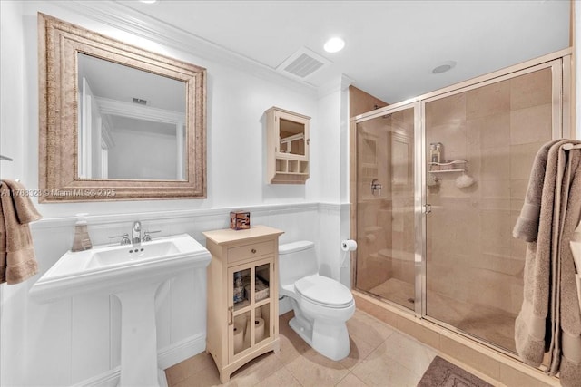 bathroom featuring a shower stall, tile patterned floors, visible vents, toilet, and crown molding