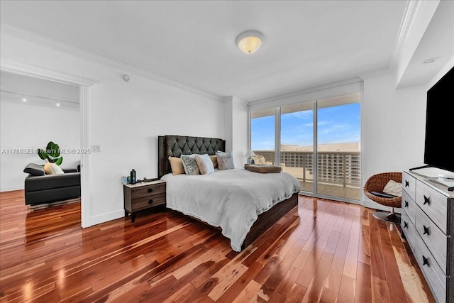 bedroom with floor to ceiling windows, hardwood / wood-style floors, ornamental molding, baseboards, and access to outside