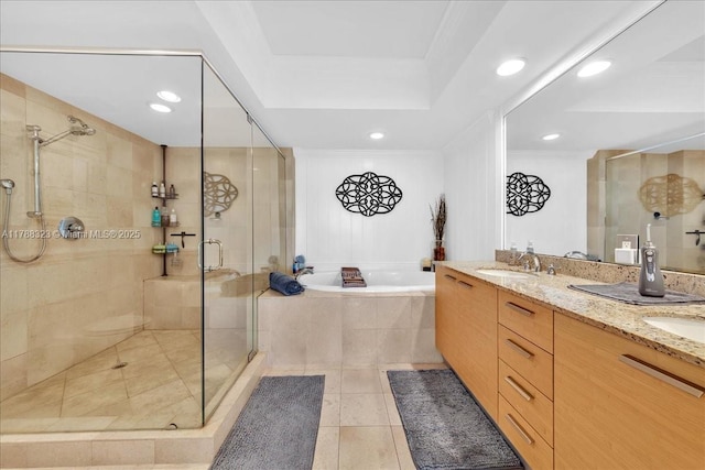full bathroom featuring a sink, double vanity, a stall shower, tile patterned flooring, and a garden tub