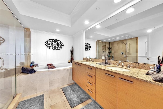 bathroom with a sink, a stall shower, double vanity, a raised ceiling, and recessed lighting