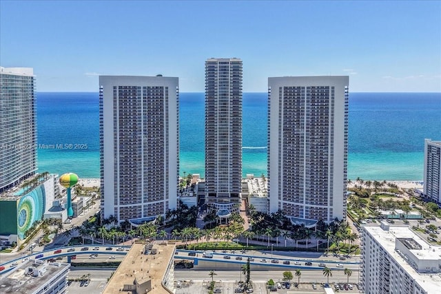 birds eye view of property featuring a city view and a water view