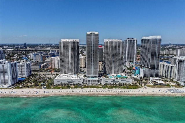 drone / aerial view with a beach view, a water view, and a view of city