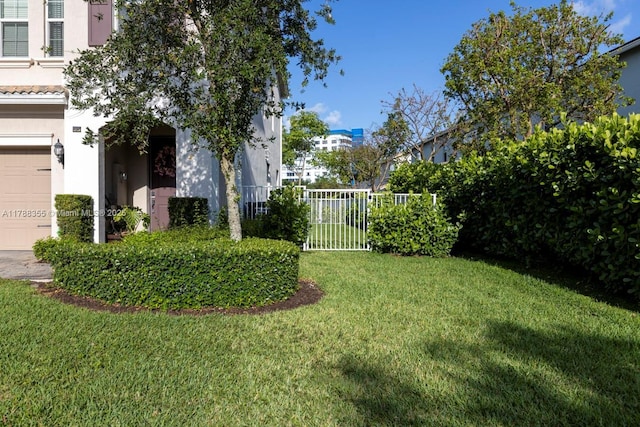view of yard with fence and a garage