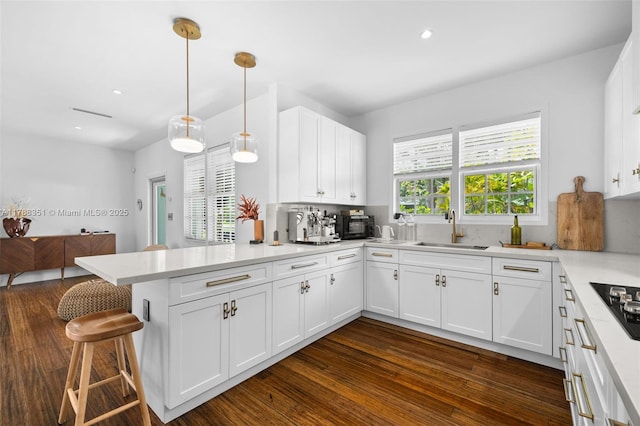 55 NE 87th St, El Portal, FL 33138 - kitchen featuring a sink, light countertops, white cabinets, and a peninsula