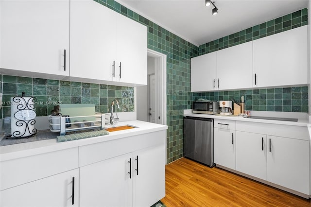 55 NE 87th St, El Portal, FL 33138 - kitchen featuring a sink, appliances with stainless steel finishes, decorative backsplash, and light countertops