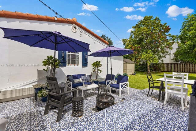 55 NE 87th St, El Portal, FL 33138 - view of patio featuring an outdoor hangout area, fence, and outdoor dining space