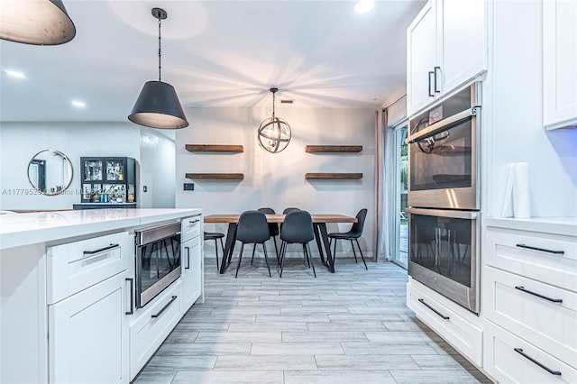 kitchen featuring appliances with stainless steel finishes, white cabinetry, open shelves, and recessed lighting