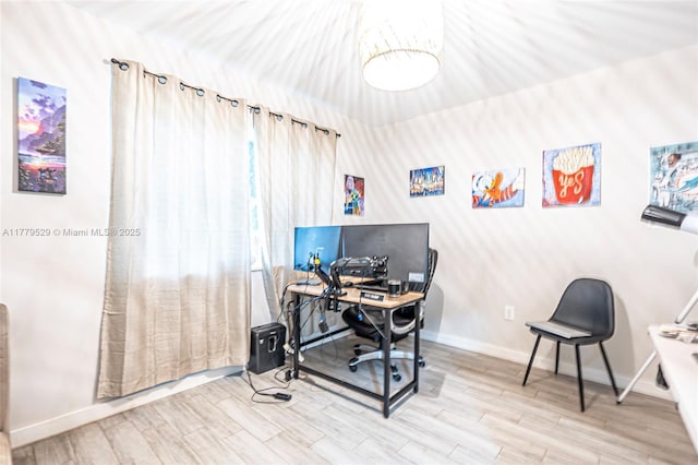 office area with baseboards and wood finished floors