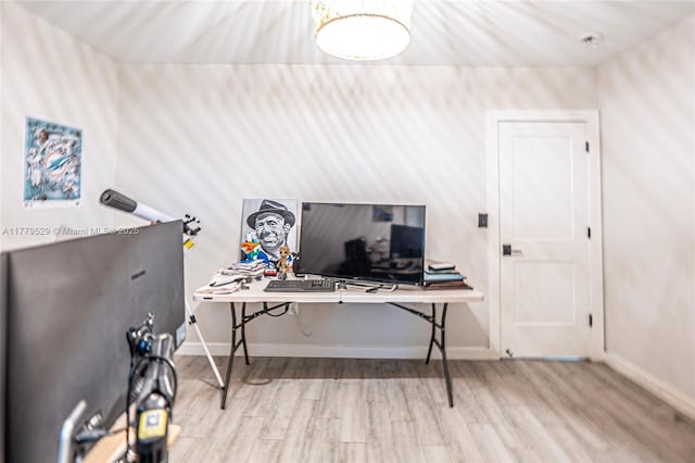 office space with wood finished floors and baseboards
