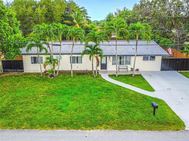 ranch-style house with stucco siding, fence, concrete driveway, and a tiled roof