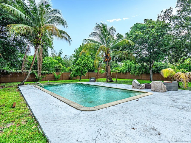view of pool featuring a patio, a fenced in pool, and a fenced backyard