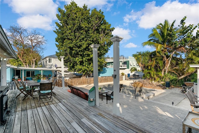 wooden terrace featuring outdoor dining space and fence