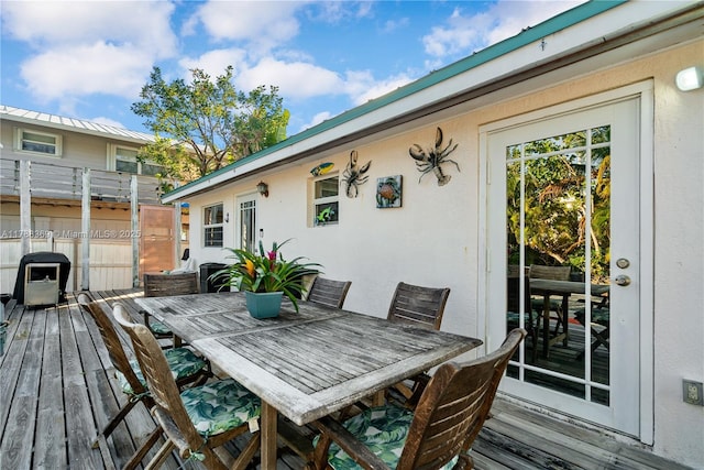 wooden deck featuring outdoor dining space